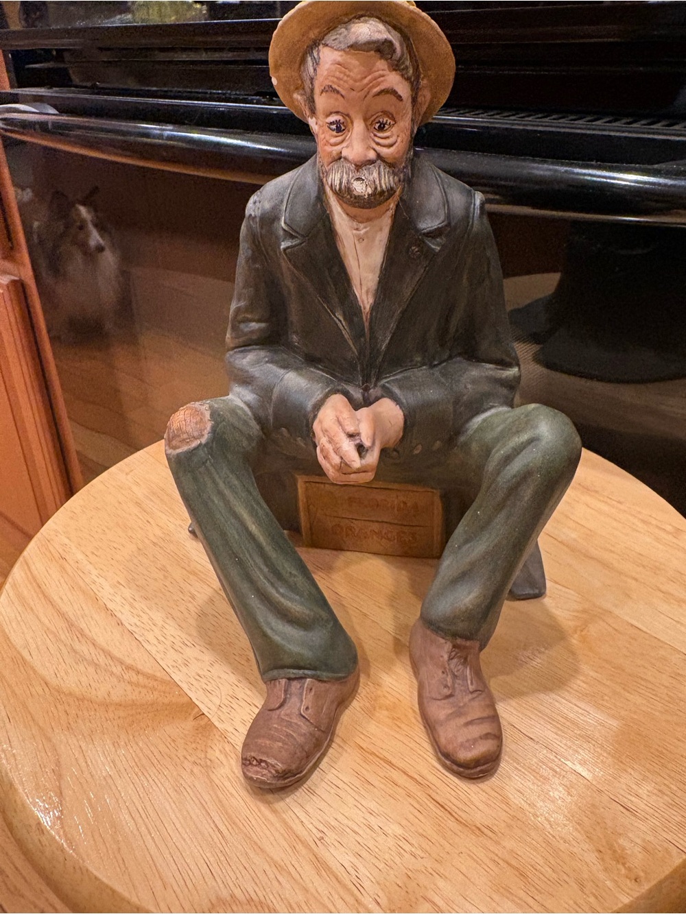 Resin Seated Gentleman Figurine in Green and Brown